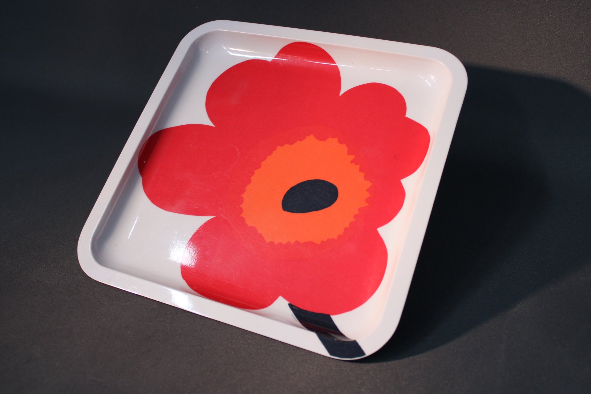 Marimekko punainen Unikko melamiini tarjoilulautanen viistosta kuvattuna