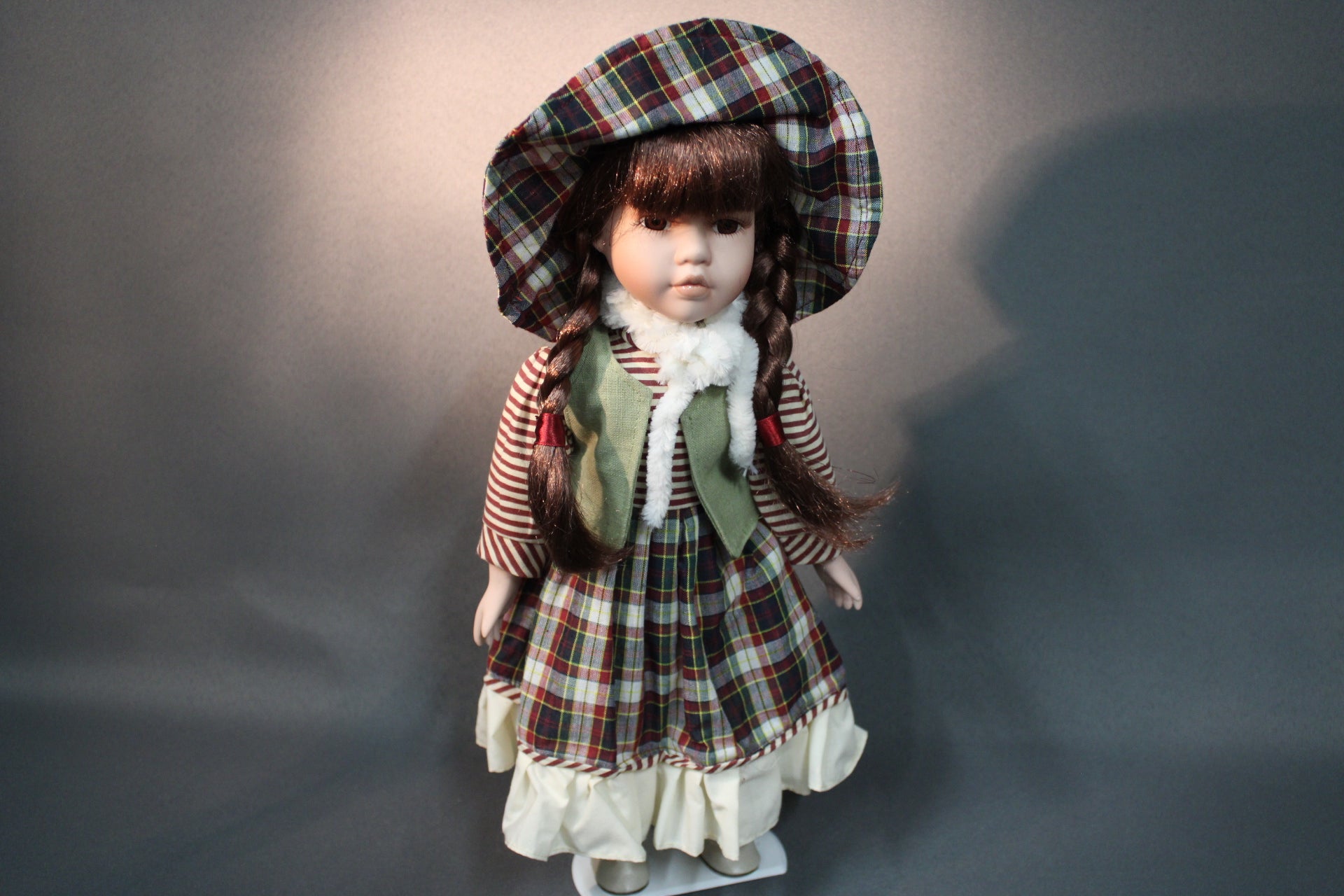 Posliininukke tyttö 40 cm, ruudullinen mekko ja hattu, edestä kuvattuna.