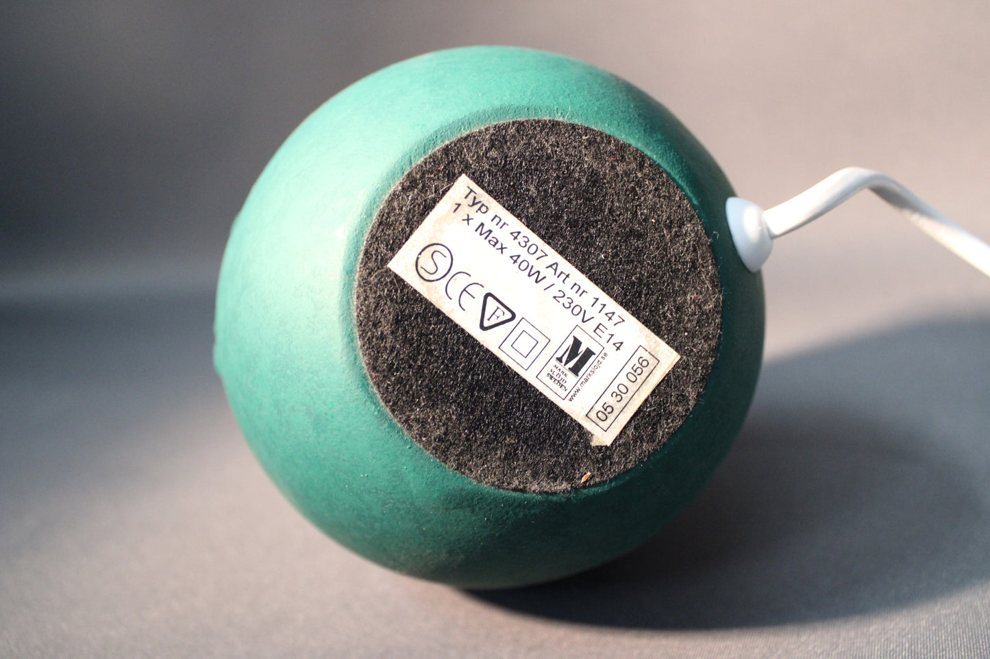 Vihreän pöytävalaisimen pohja ja valmistajan merkintä